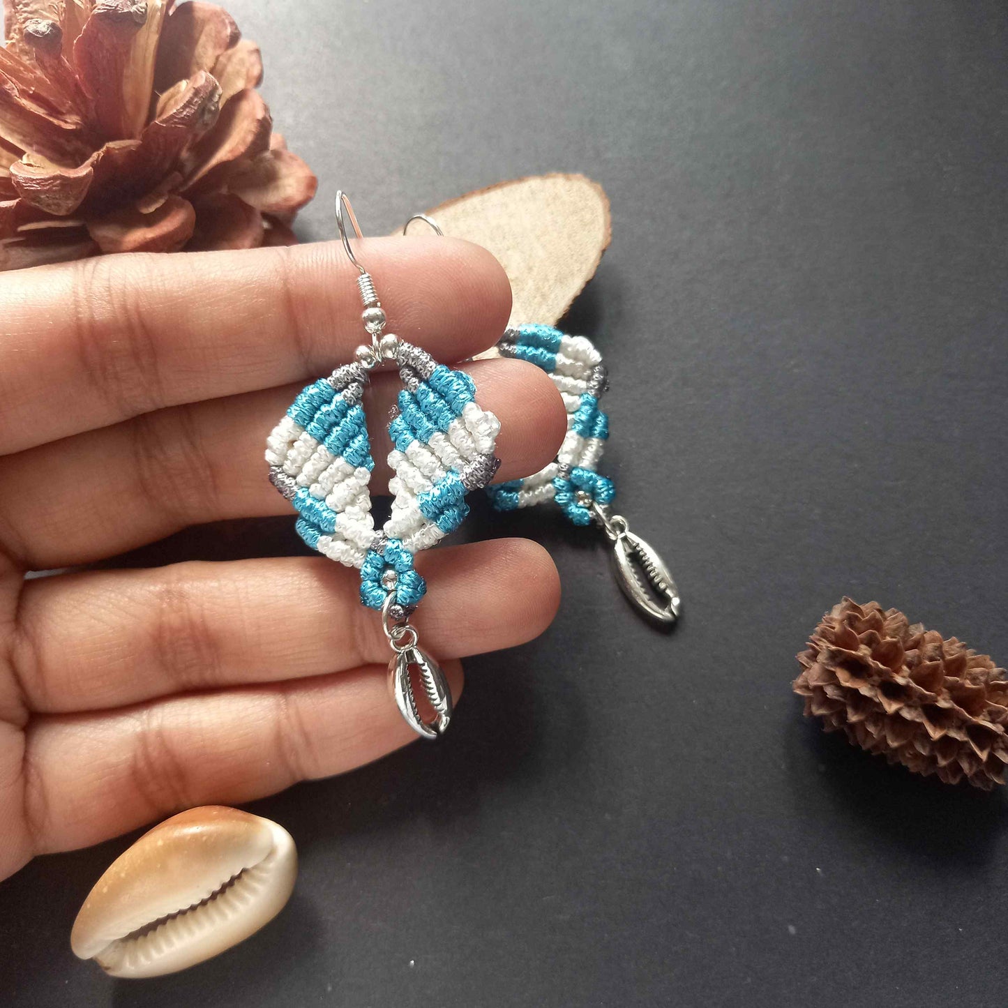 diamond shaped macrame earrings in three colours with a coil of rope charm