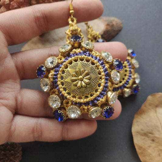 gold stone earrings with blue and white rhinestones