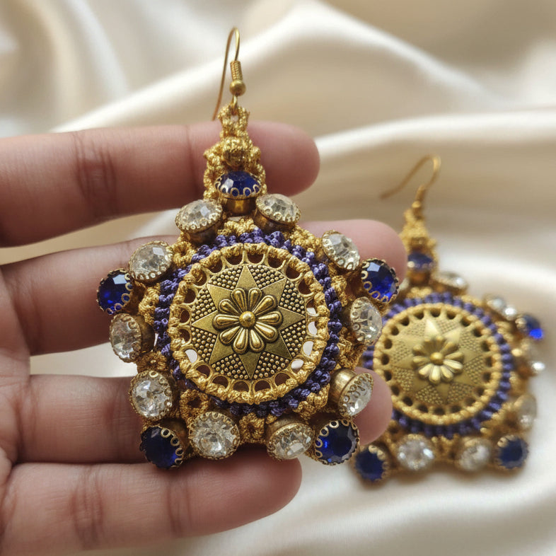 gold stone earrings with blue and white rhinestones