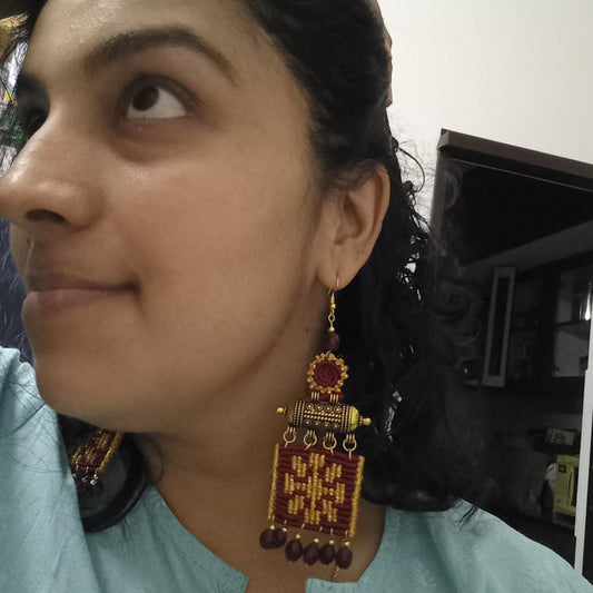 dangler bead earrings featuring a rod pendant and cavandoli macrame floral design