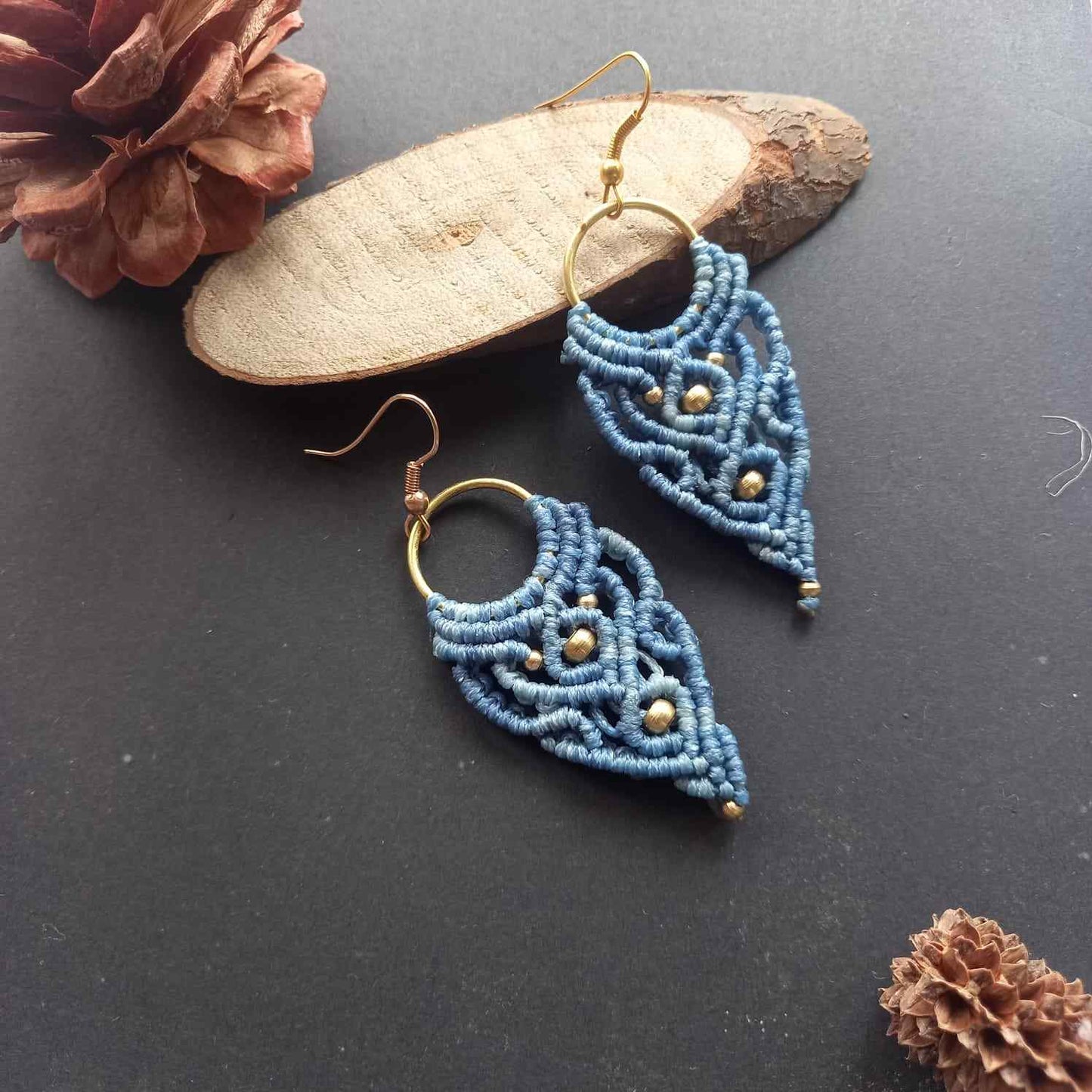 blue handmade macrame earrings with a lace like design and brass beads