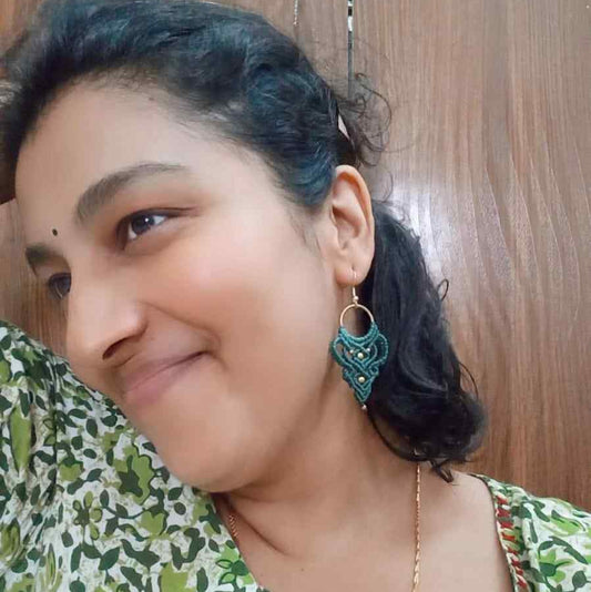 dark green handmade macrame earrings with a lace like design and brass beads