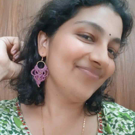 purple handmade macrame earrings with a lace like design and brass beads