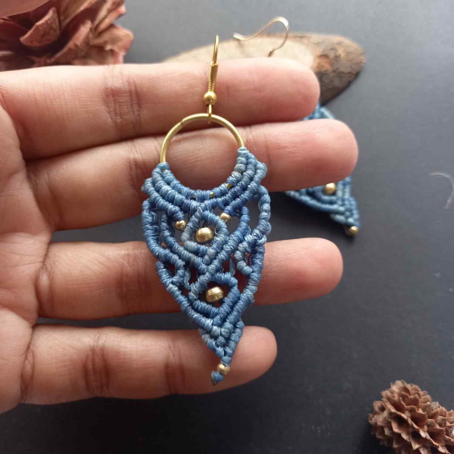 blue handmade macrame earrings with a lace like design and brass beads