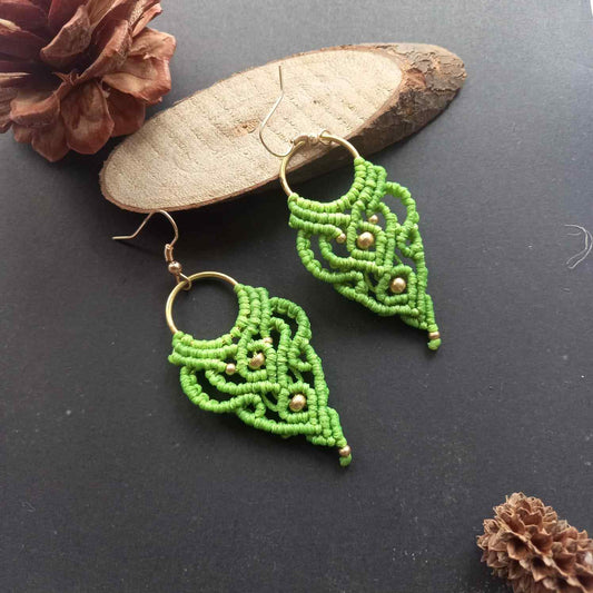 light green handmade macrame earrings with a lace like design and brass beads