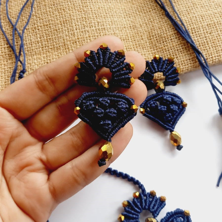 blue macrame pendant earrings set with faceted metallic purple beads