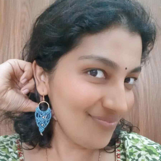 blue handmade macrame earrings with a lace like design and brass beads