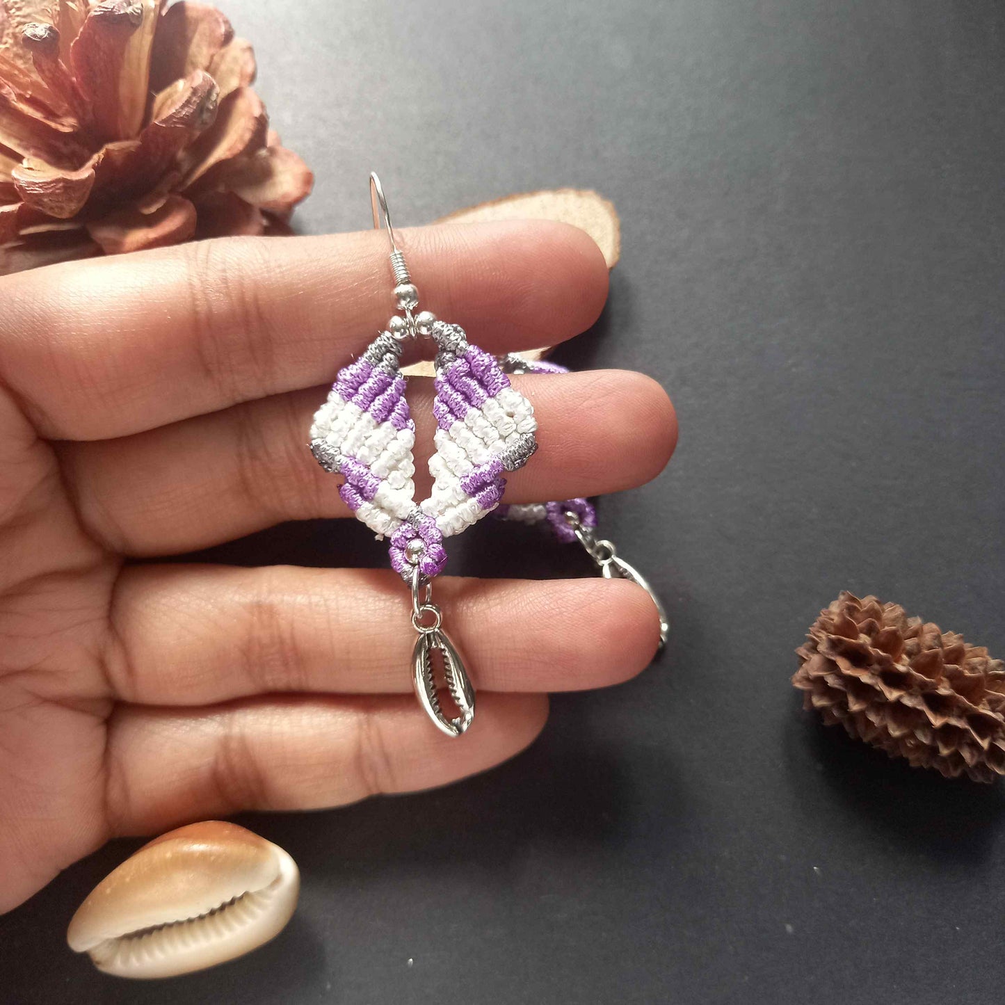 diamond shaped macrame earrings in three colours with a coil of rope charm