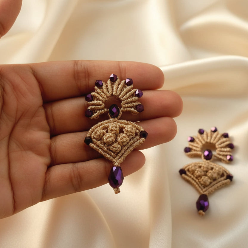 beige macrame pendant earrings set with faceted metallic purple beads