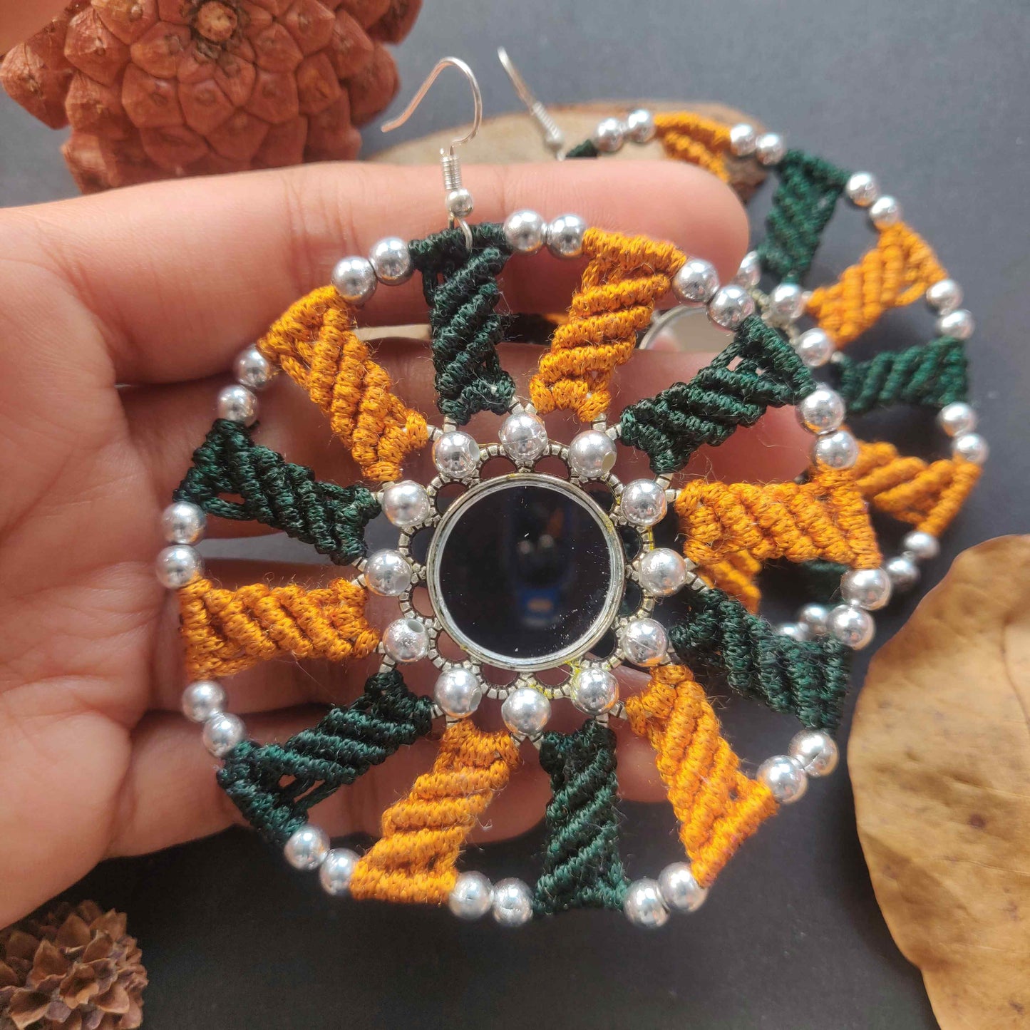 silver mirror earrings with macrame work in dark green and mustard