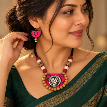Medini fabric necklace set — semicircular crimson and black pendant with a clay centre hand-painted with a black and white mandala design