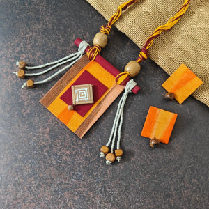 Mrinmayi orange fabric necklace set — rectangular orange ikkat pendant with a maroon applique and hand-painted terracotta motif, with stud dangler earrings