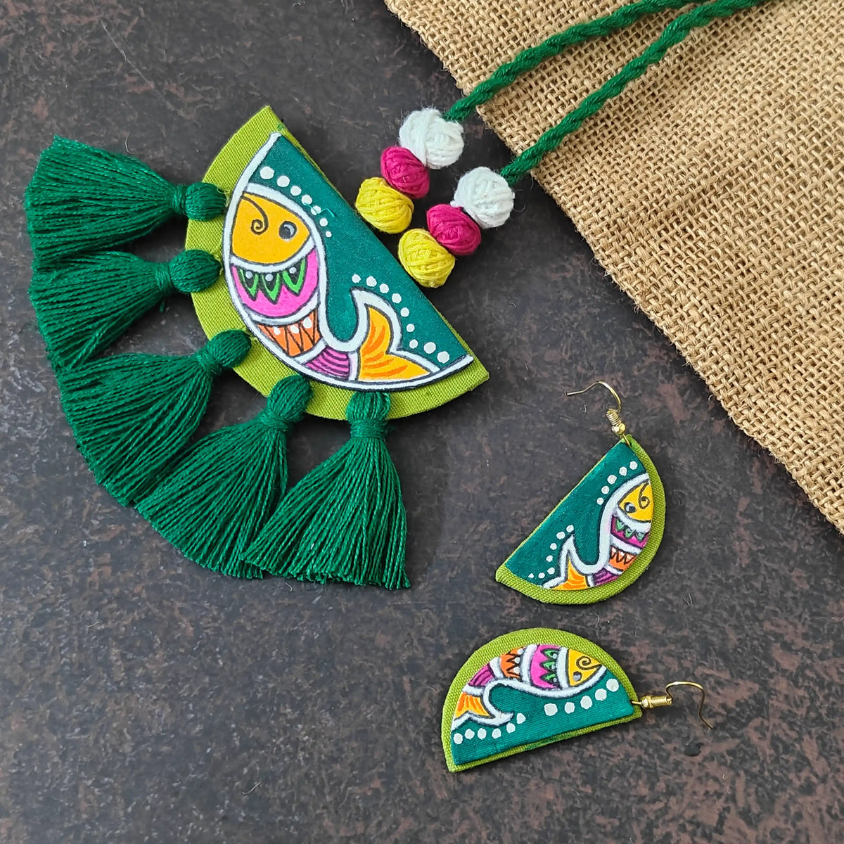 Pratima green fabric necklace set — semicircular pendant with a hand-painted fish and green cotton thread tassels, with small matching fish earrings