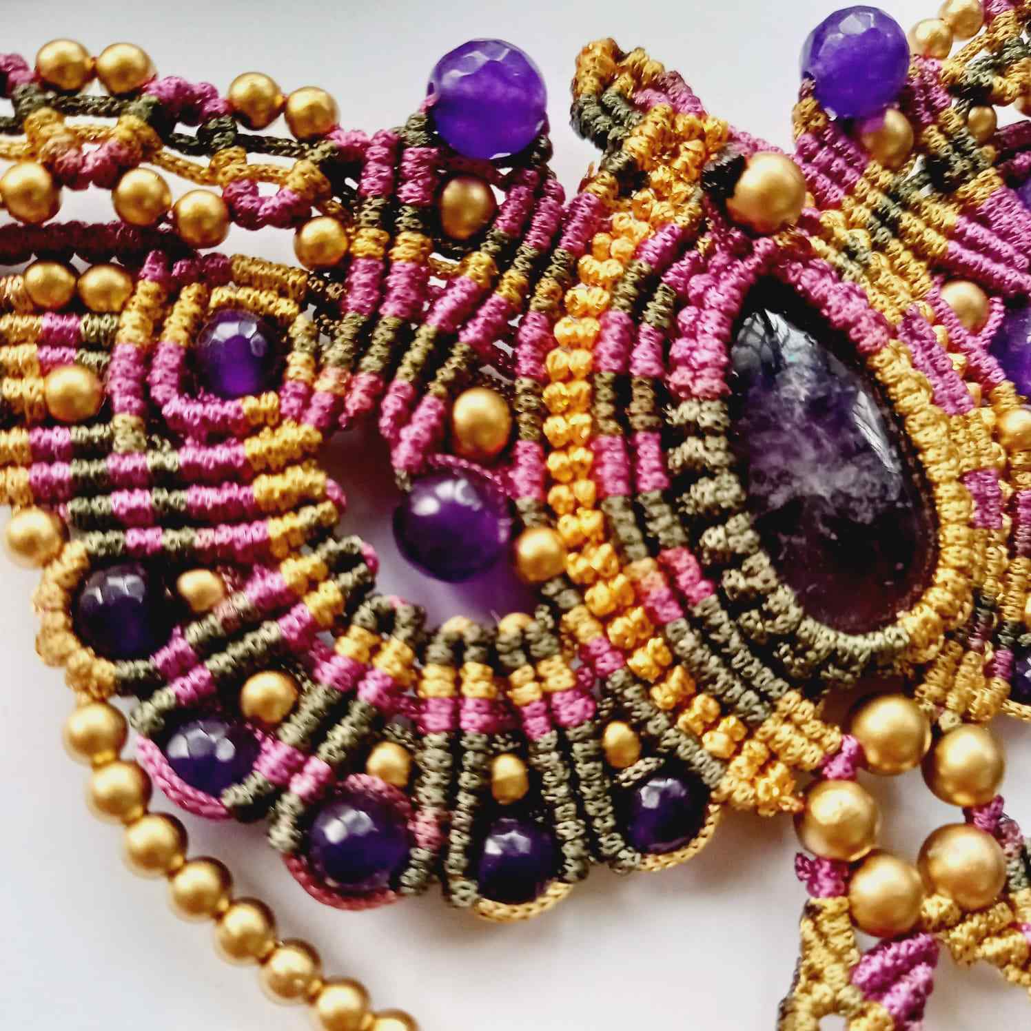 macrame pendant earrings set in the shape of a butterfly featuring amethyst stones and agate beads