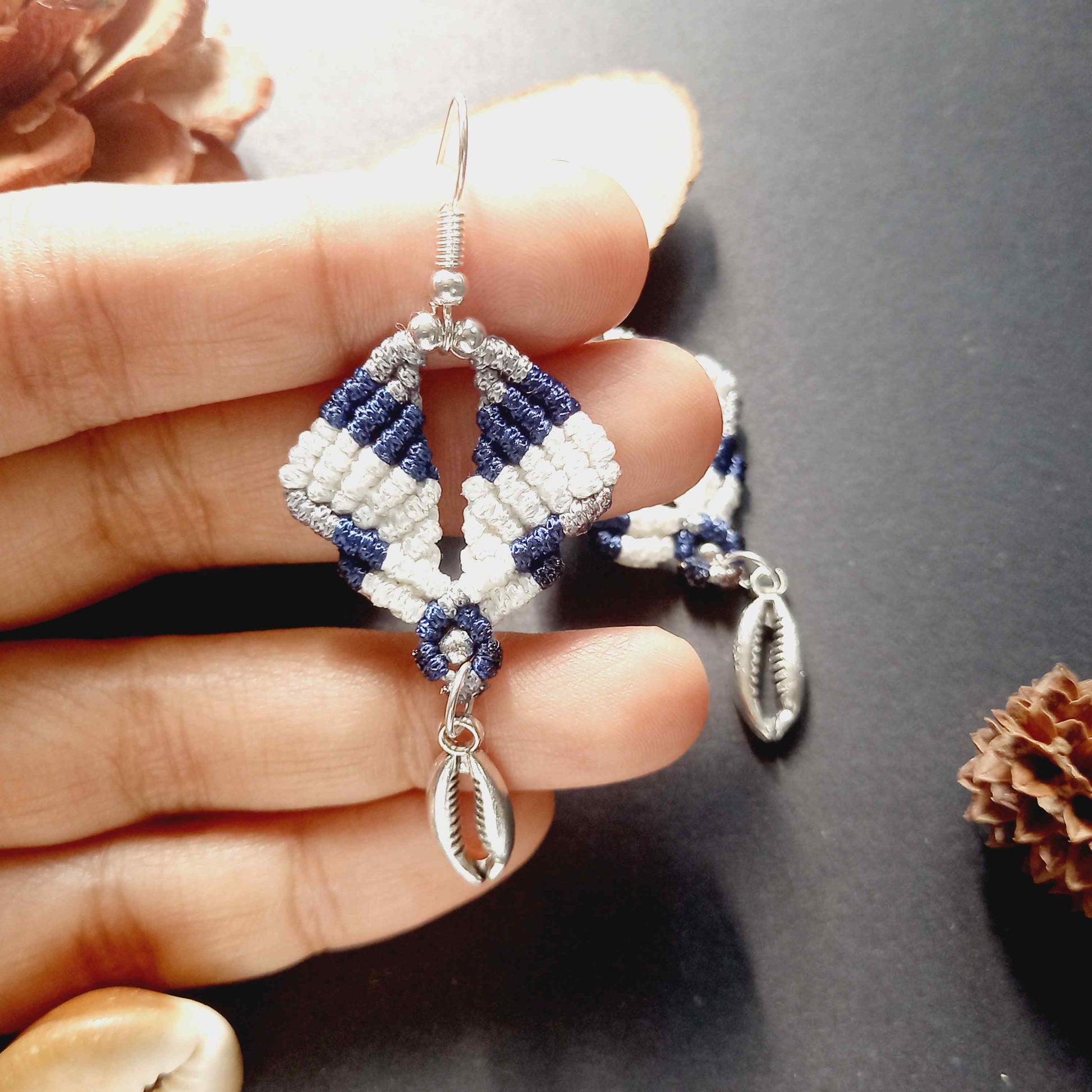 diamond shaped macrame earrings in three colours with a coil of rope charm