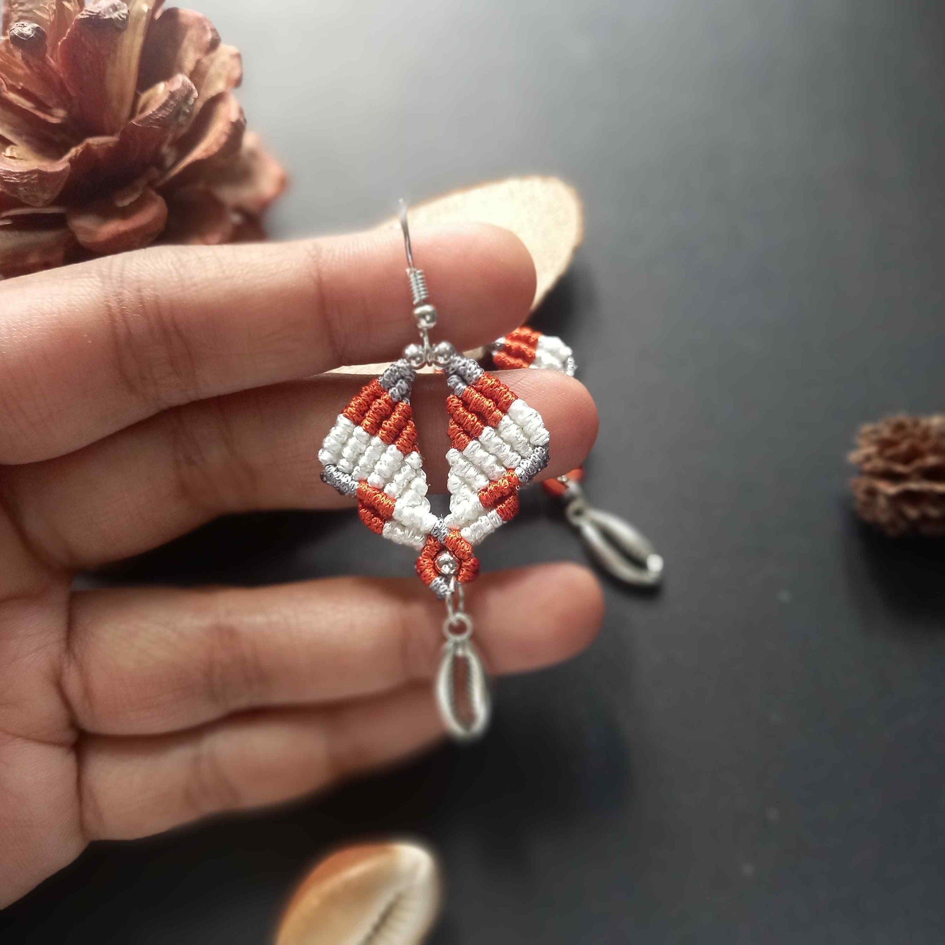 diamond shaped macrame earrings in three colours with a coil of rope charm