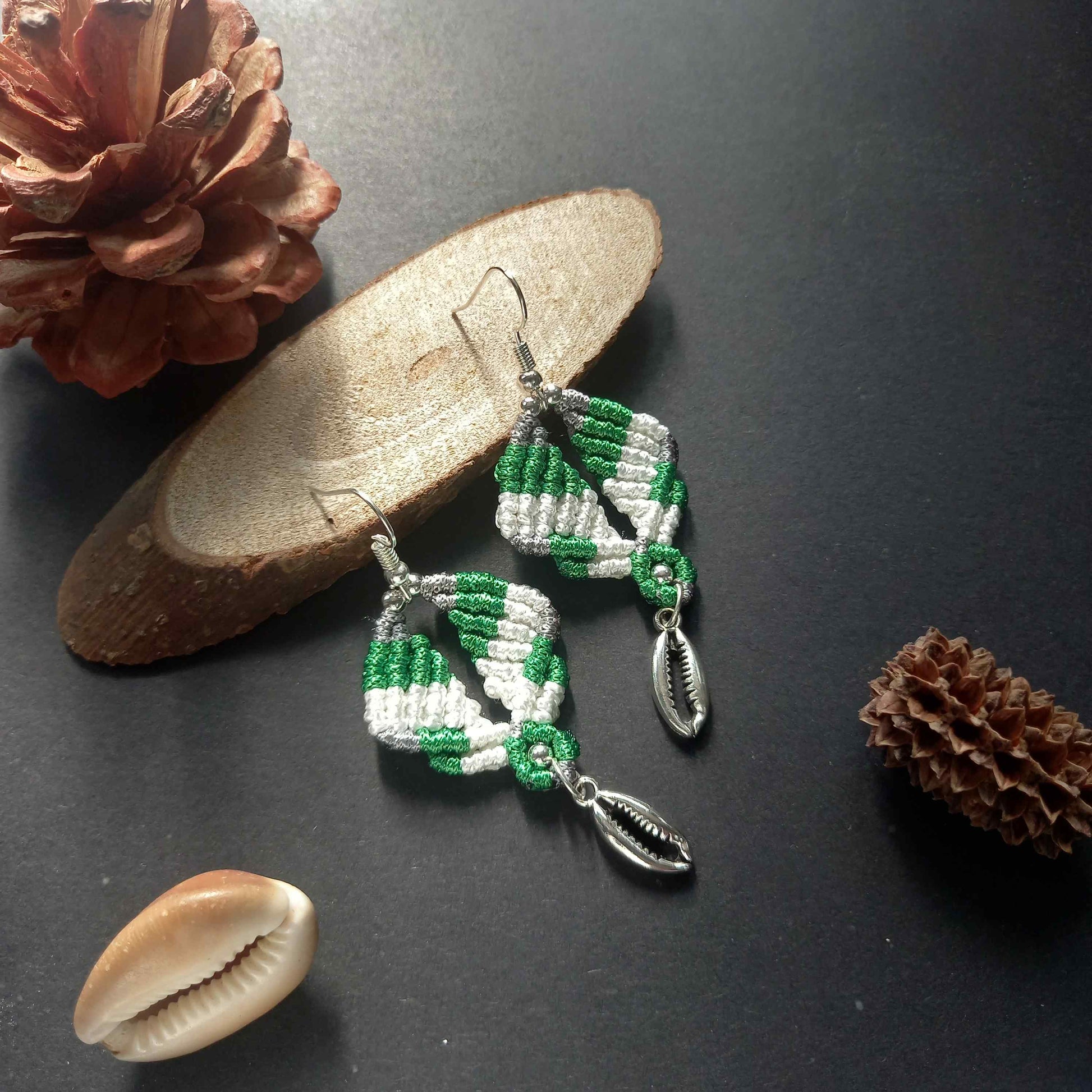 diamond shaped macrame earrings in three colours with a coil of rope charm