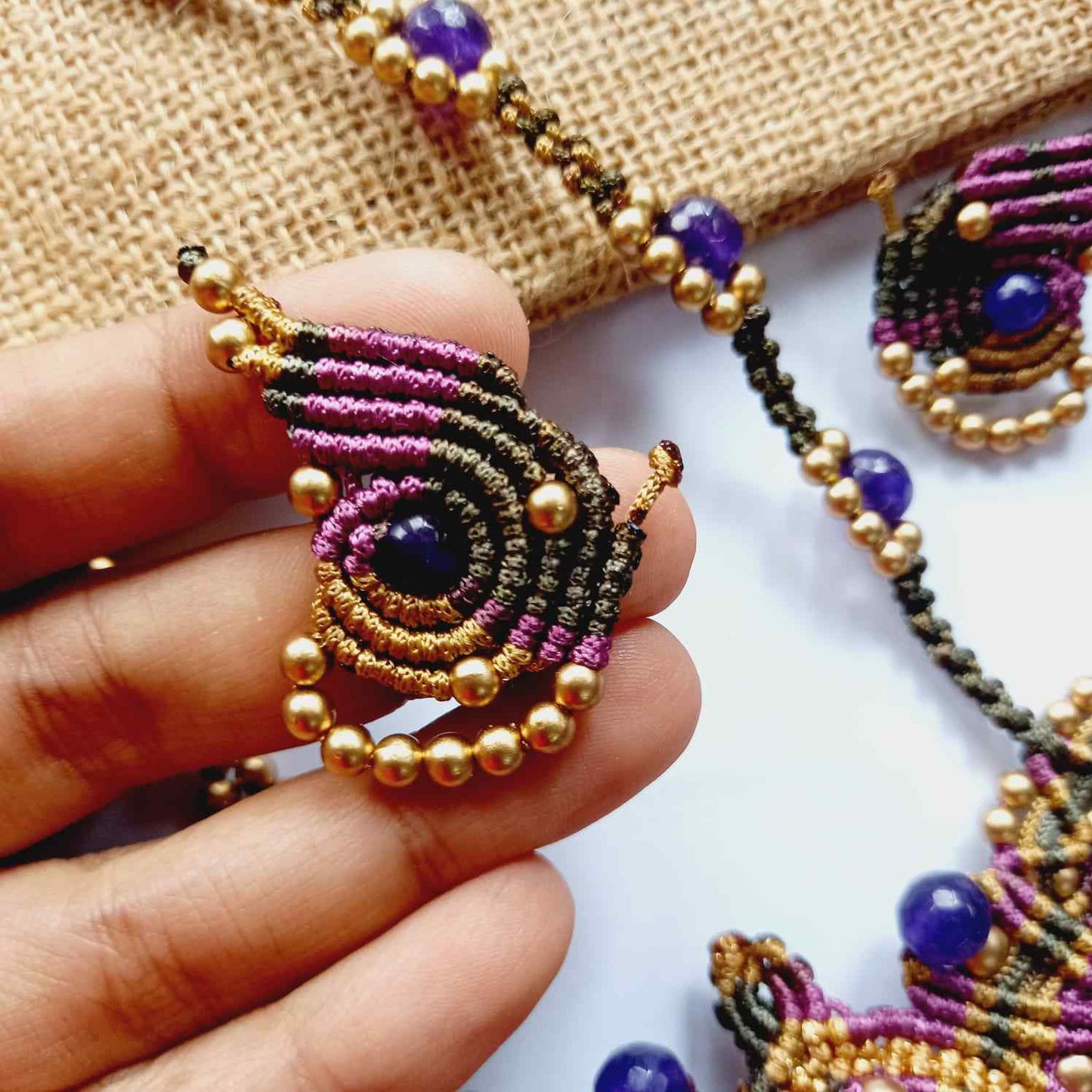macrame pendant earrings set in the shape of a butterfly featuring amethyst stones and agate beads