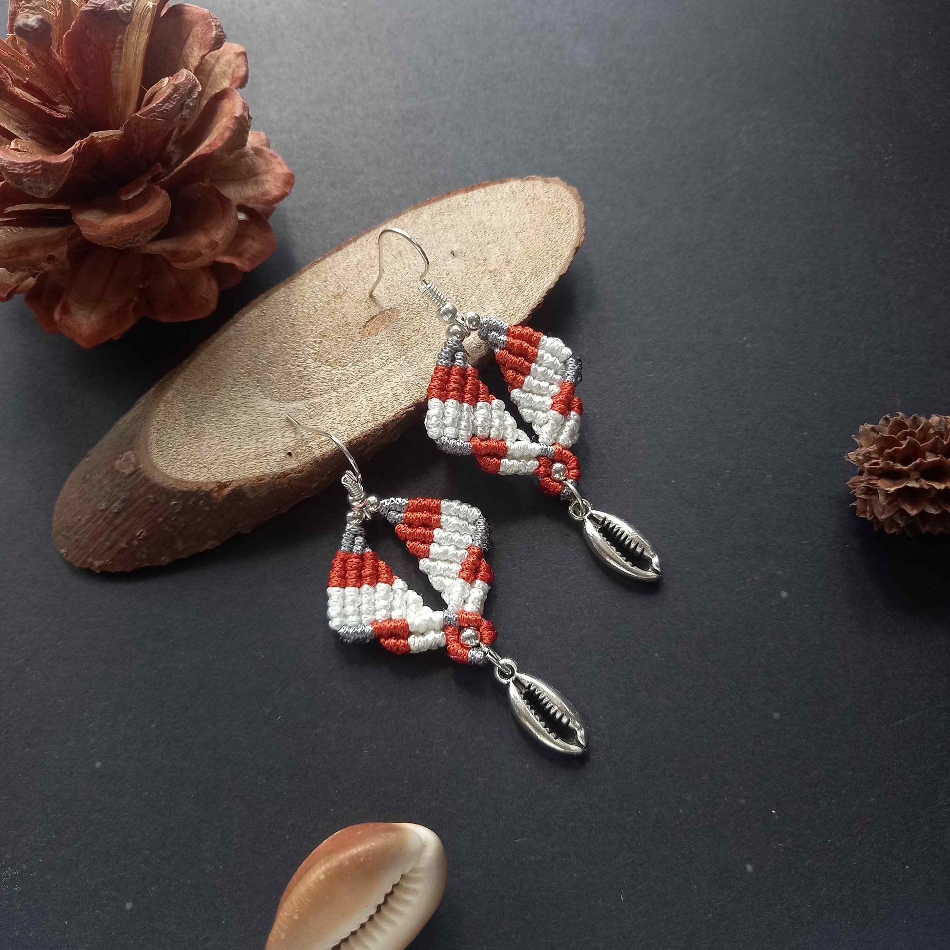 diamond shaped macrame earrings in three colours with a coil of rope charm
