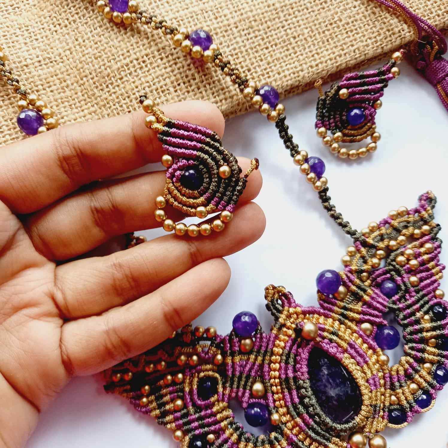macrame pendant earrings set in the shape of a butterfly featuring amethyst stones and agate beads