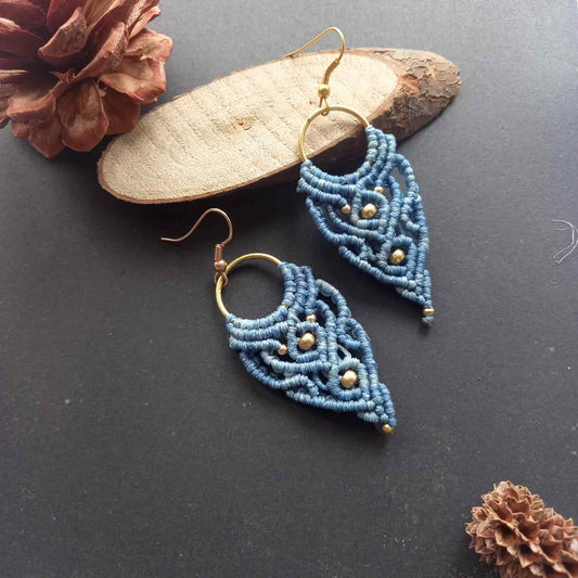 blue handmade macrame earrings with a lace like design and brass beads