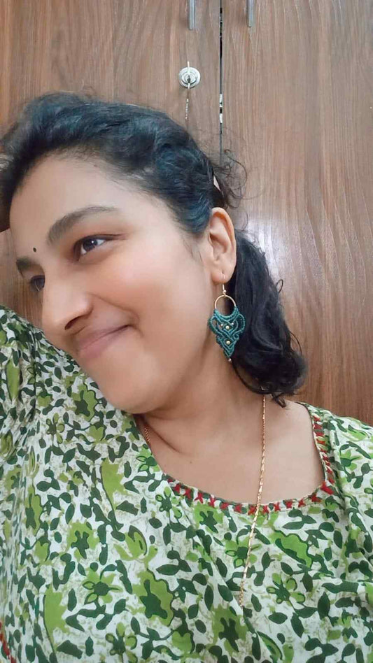 dark green handmade macrame earrings with a lace like design and brass beads