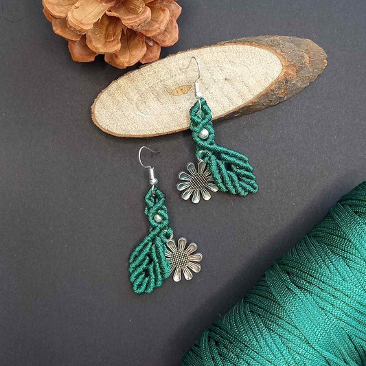 macrame dangler earrings featuring a single leaf over a silver daisy charm