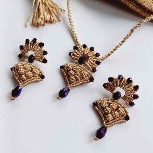 beige macrame pendant earrings set with faceted metallic purple beads