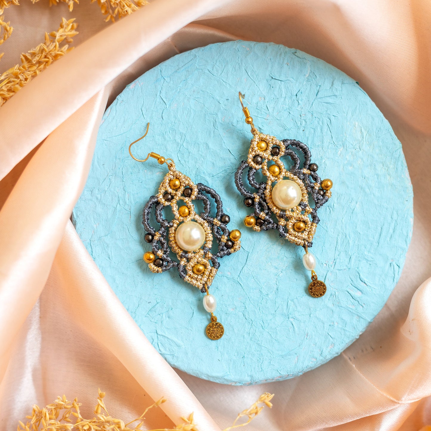 macrame dangler earrings with a pearl center and gold coin charm