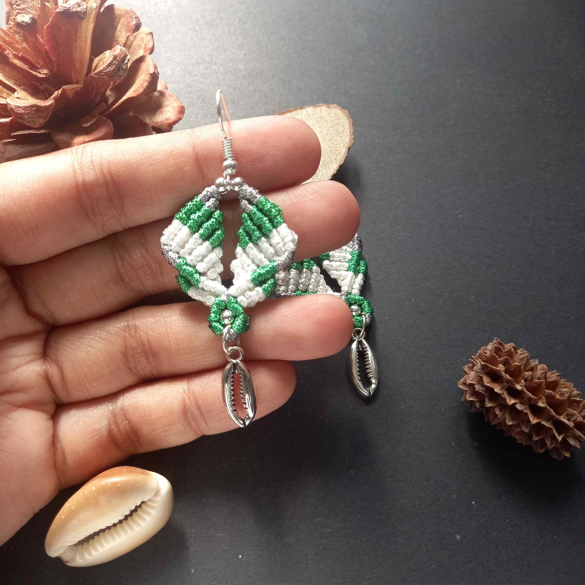 diamond shaped macrame earrings in three colours with a coil of rope charm