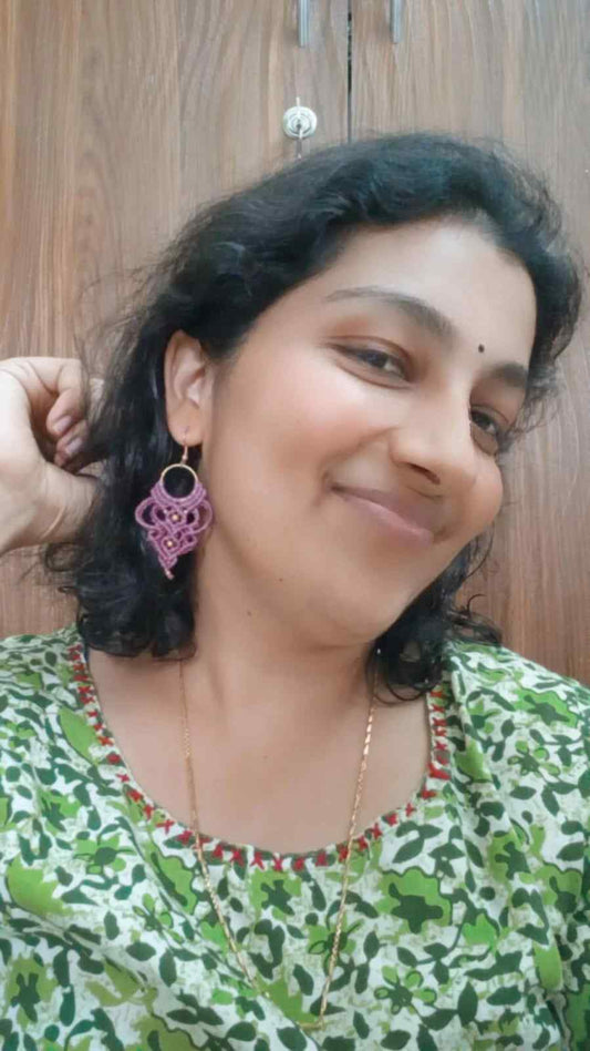 purple handmade macrame earrings with a lace like design and brass beads