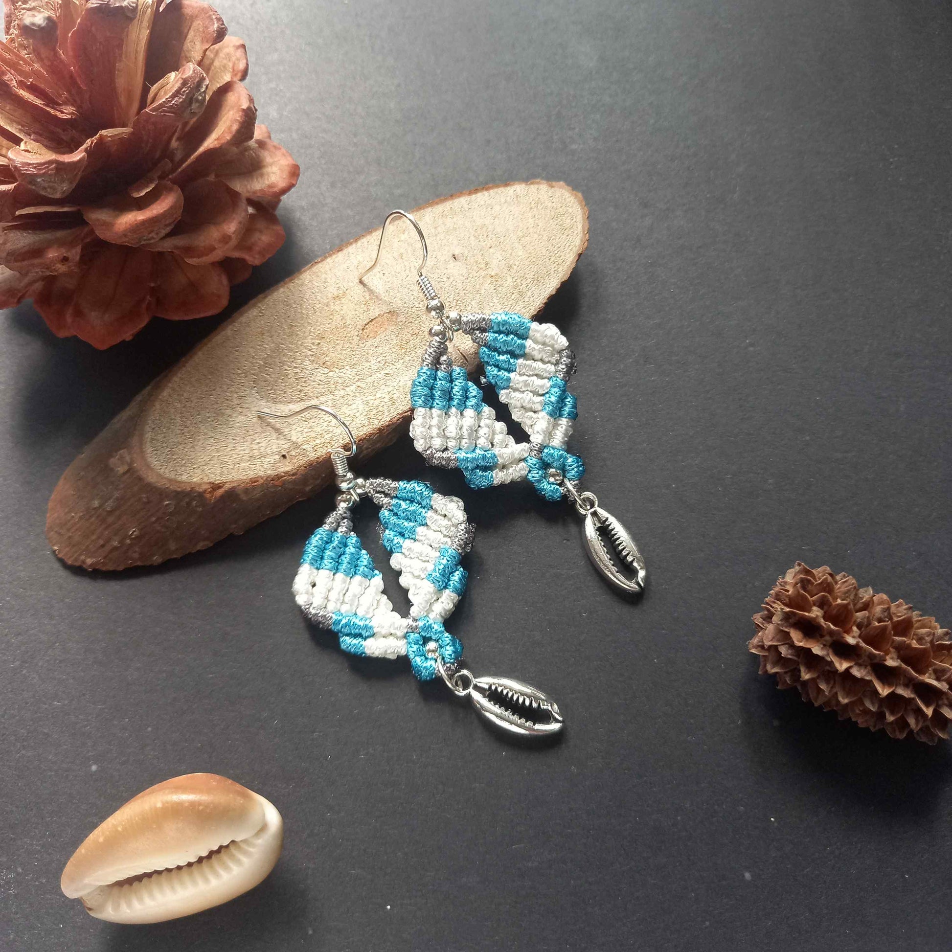 diamond shaped macrame earrings in three colours with a coil of rope charm