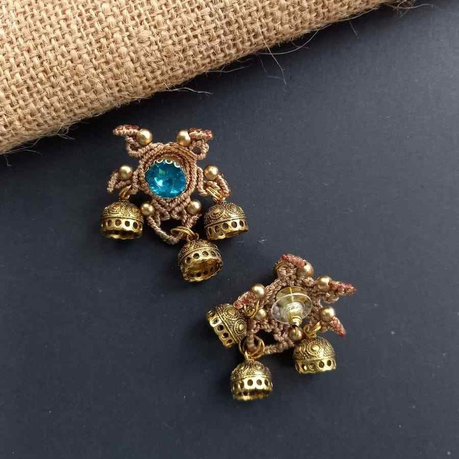 unusual stud earrings with macrame work around a blue rhinestone and three jhumkis