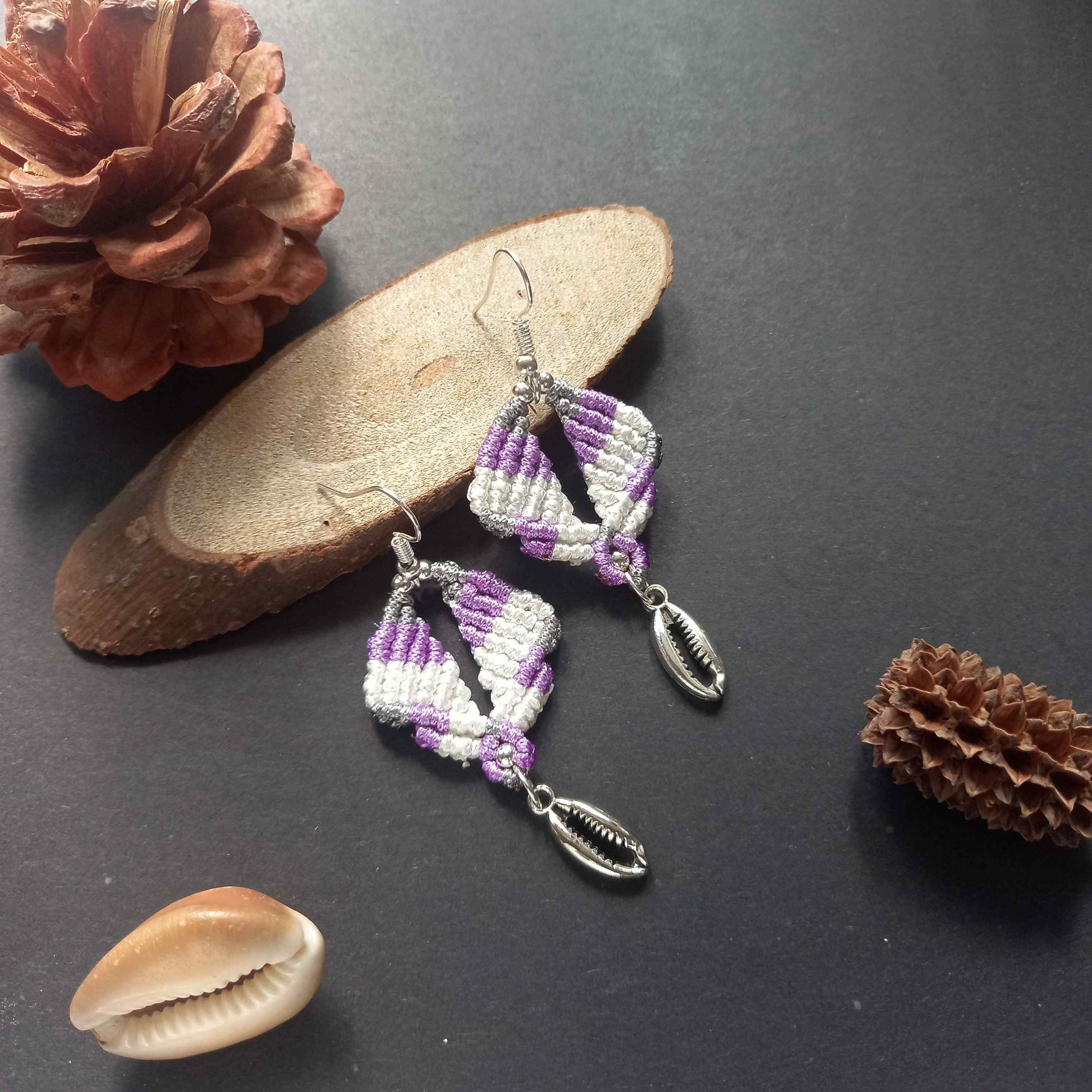 diamond shaped macrame earrings in three colours with a coil of rope charm
