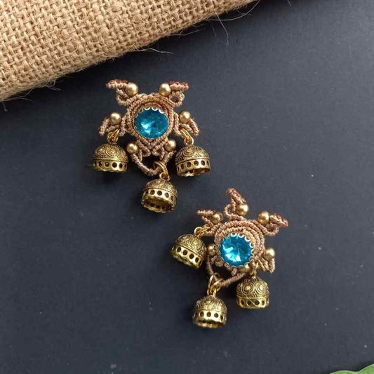 unusual stud earrings with macrame work around a blue rhinestone and three jhumkis
