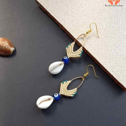 cowrie shell dangler earrings with evil eye bead